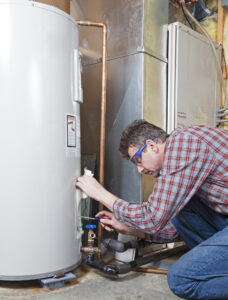Tank water heater getting flushed by a plumber