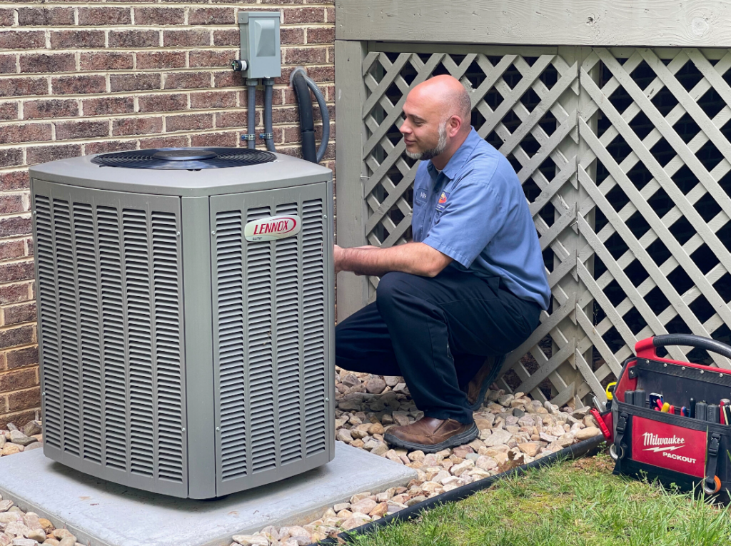 AC technician installing a Lennox air conditioner