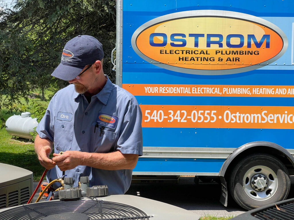 Ostrom technician with a service vehicle in the background.