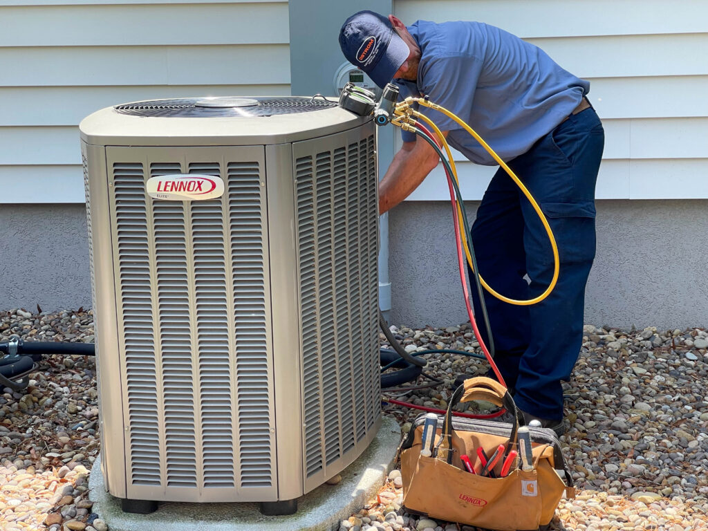 Ostrom AC technician repairing an air conditioner