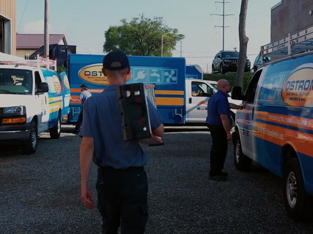 Ostrom employee walking toward an Ostrom service van