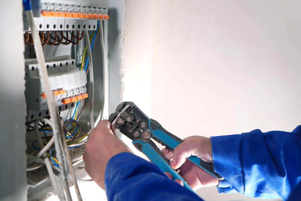 Electrician works with internet cable wiring.