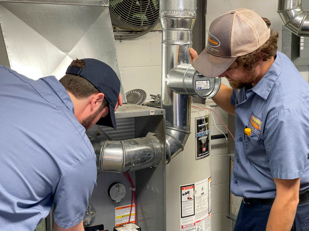 Ostrom technician servicing a furnace.