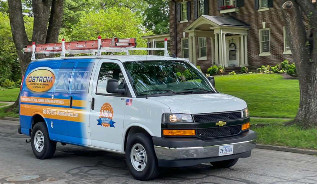 Ostrom truck parked outside of large brick home.